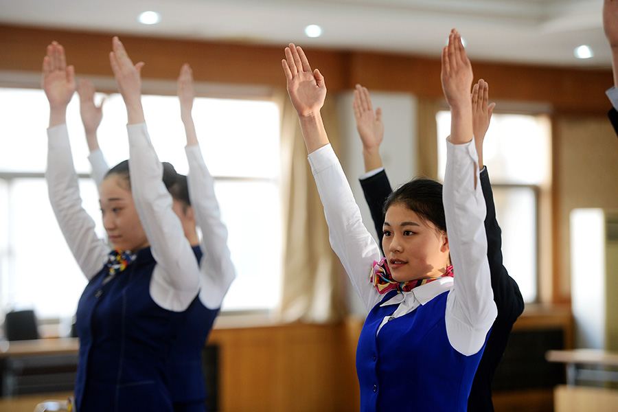 Candidates do squats, sing and dance to become train attendants