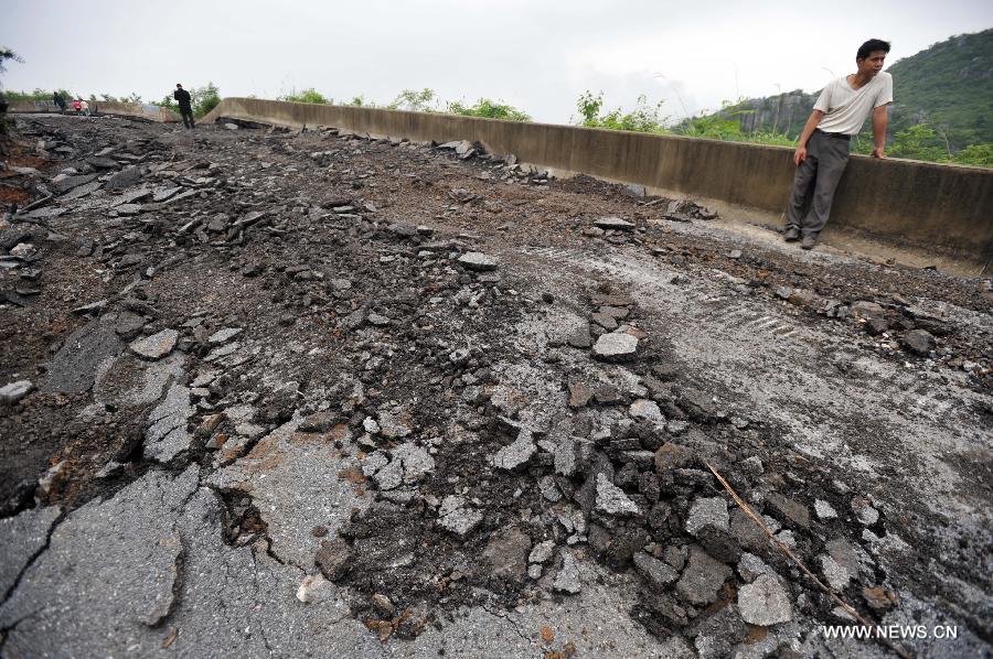 Road destroyed by rain-triggered floods in S China