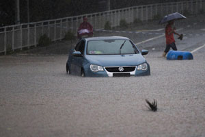 Road destroyed by rain-triggered floods in S China