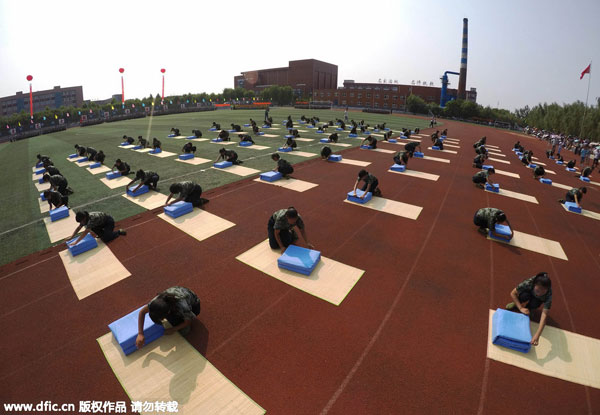 Freshmen fold quilts in 80 sec during military training