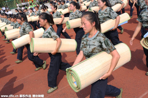 Freshmen fold quilts in 80 sec during military training