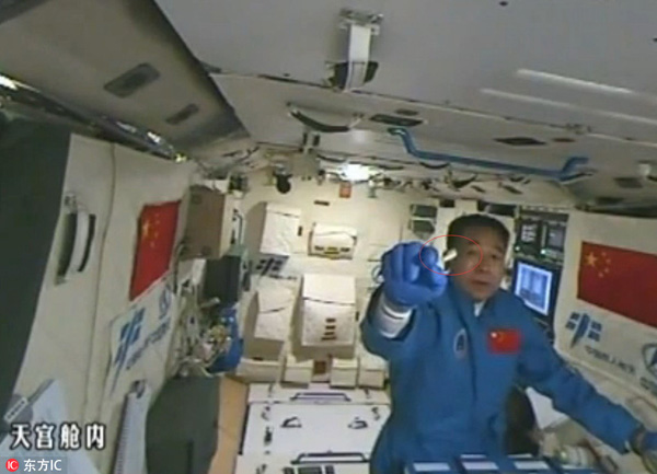 Astronaut plays with silkworms in Tiangong II