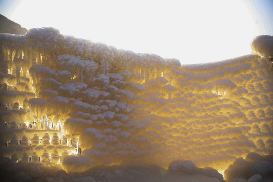 Visitors view frozen Hukou Waterfall on Yellow River