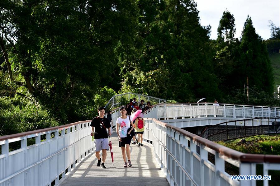 People enjoy scenery at high altitude sight-seeing footpath in Taiwan