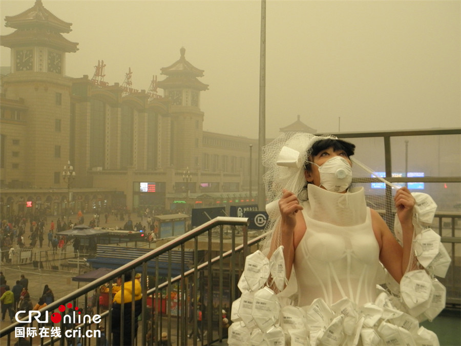 Artist appeals to public to combat smog with respirator wedding dress