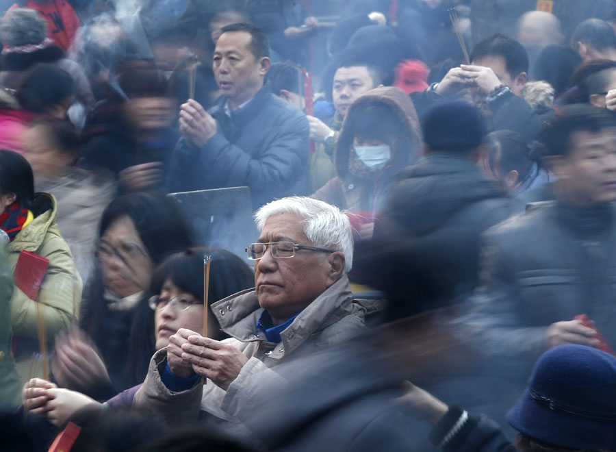 People pray on the first day of Chinese New Year