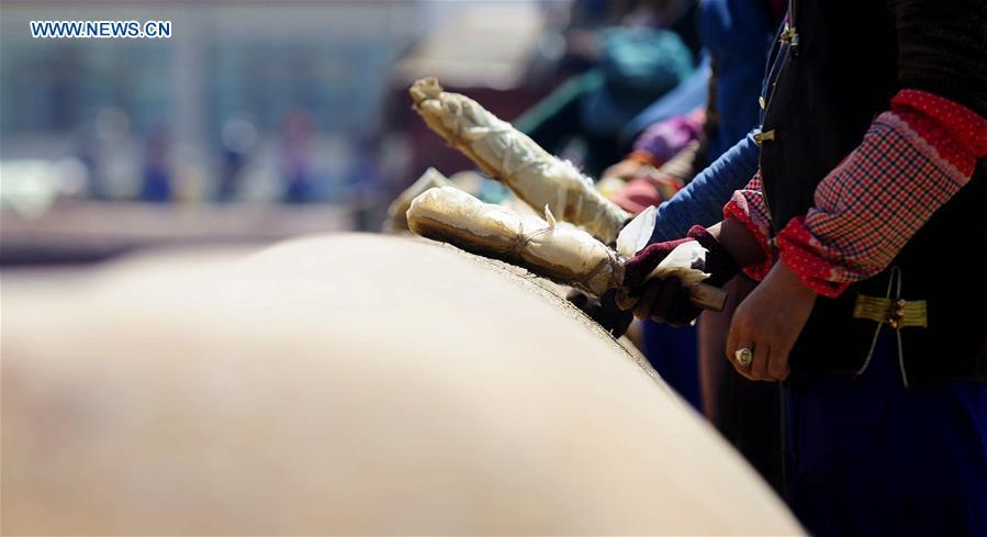 Craftswomen repair roof of Tibet monastery