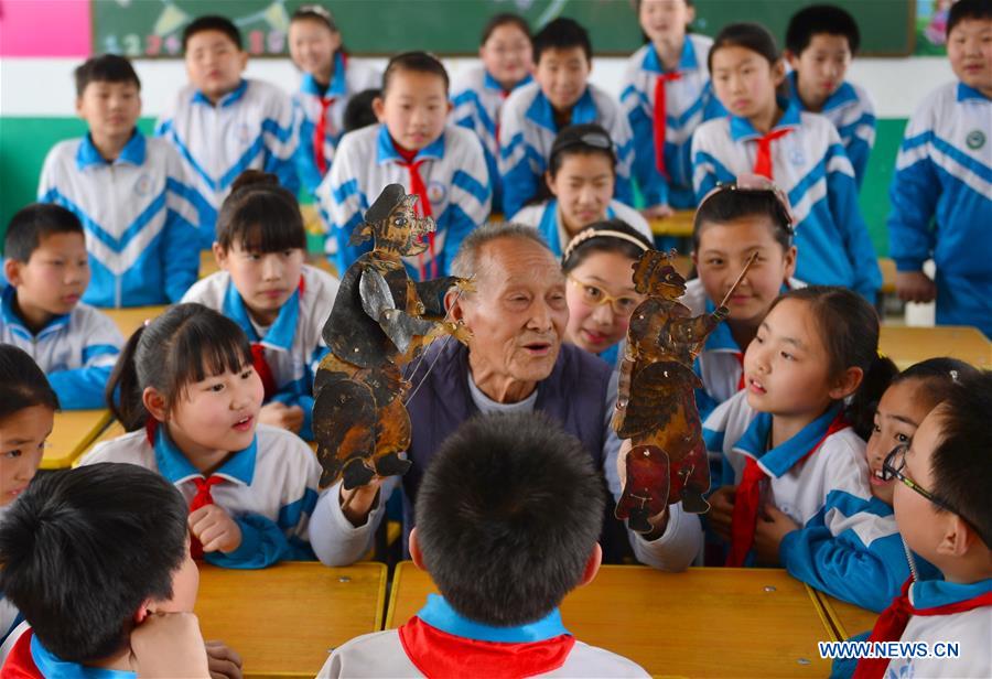 Shadow puppet artists teach students traditional culture in N China