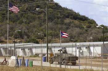 This is a Feb. 13, 2003 file photo showing a military Humvee patrolling the perimeter of Camp America in Guantanamo Bay Naval Base, Cuba. (AP 