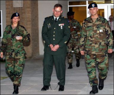 Specialist Charles Graner is escorted to a military prison in shackles after his court-martial in Fort Hood, Texas. He was sentenced to 10 years after having been convicted of dereliction of duty, maltreatment of detainees, assault of detainees, and indecency with detainees while serving at the Abu Ghraib prison in Iraq. [AFP/file]