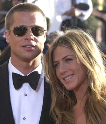 Jennifer Aniston, right, and husband Brad Pitt pose for photographers on as they arrive for the 56th Annual Primetime Emmy Awards Sunday, Sept. 19, 2004, at the Shrine Auditorium in Los Angeles. Aniston is nominated for outstanding lead actress in a comedy series for her work on 'Friends.' [AP]