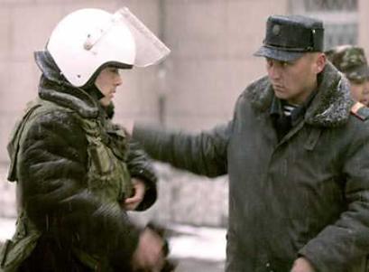 A Kyrgyz police officer pats the shoulder of another policeman before he goes on patrol in the capital, Bishkek, March 27, 2005. (Viktor Korotayev/Reuters) 