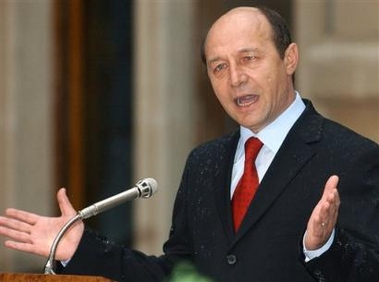 Romanian President Traian Basescu gestures while addressing the media in Bucharest Sunday May 22, 2005.Three Romanian journalists were freed Sunday after nearly two months held hostage in Iraq, President Traian Basescu said.The journalists were in the custody of Romanian authorities and were expected home Monday, he said. (AP