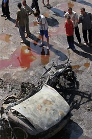 Iraqis gather at an explosion site in central Baghdad, Wednesday, Sept. 14, 2005. 