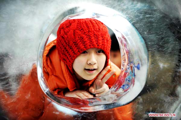 People enjoy ice sculptures in Harbin