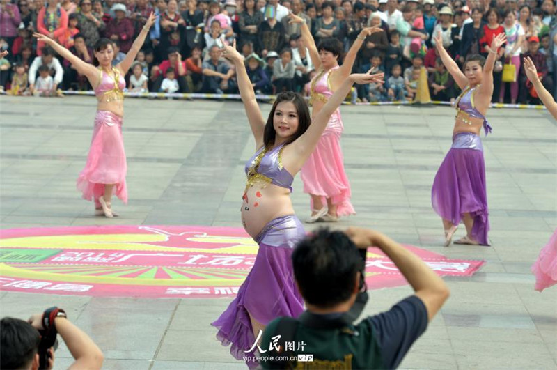 Pregnant women belly dance in street performance