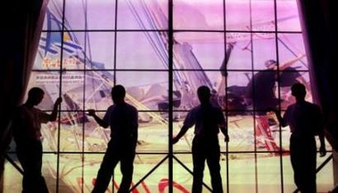 Workers at the 2006 Qingdao International Regatta sailing competition wait outside the main hall during the opening ceremony in Qingdao, China's eastern province of Shandong, August 20, 2006. The races begin on August 21, with the regatta as the first trial of an official venue for the upcoming 2008 Summer Olympics.