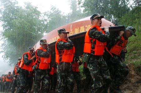 Chinese armed police remove boats during a drill in Nanning, South China's Guangxi Zhuang Autonomous Region, June 4, 2007. The drill aimed to enhance the armed police' skills in fighting against the possible flood during the summer. Natural disasters including typhoons, floods and droughts killed 3,186 people in China in 2006, the death toll rising 28.7 percent on the previous year, Xinhua news agency reported in later May.[Xinhua]