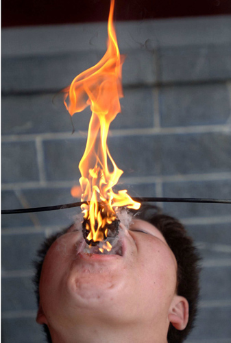 Fire-swallowing man