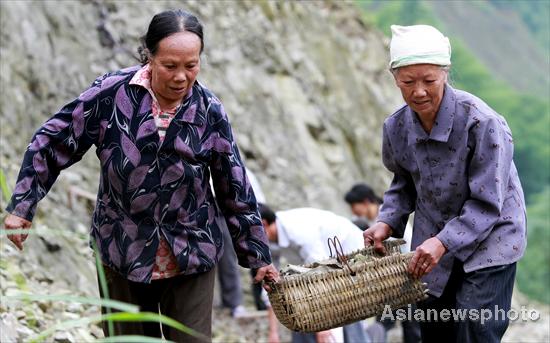 Villagers rebuild sole road after flood