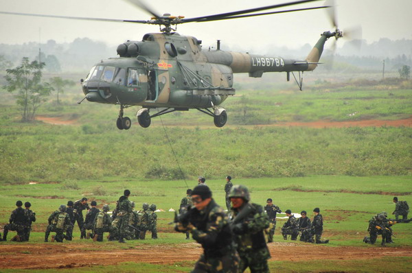 Soldiers rope down from helicoper in joint drill