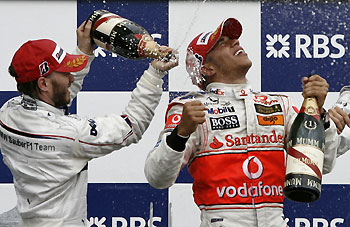 McLaren Formula One driver Lewis Hamilton (R) of Britain, winner of the Canadian F1 Grand Prix, is sprayed with champagne by second-placed BMW driver Nick Heidfeld of Germany in Montreal, June 10, 2007. Hamilton won his first Formula One race in a crash-marred Canadian Grand Prix.