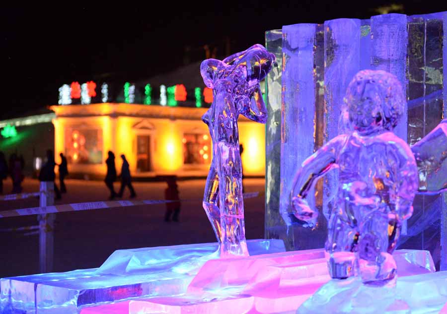 Tourists view shimmering ice sculptures in China's Harbin