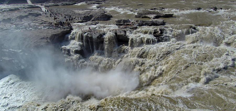 Surging water at Hukou Waterfall attracts tourists