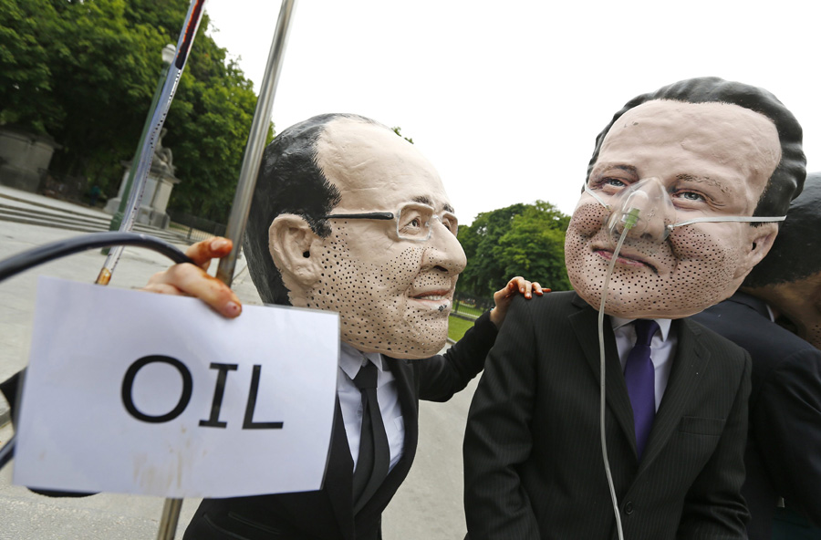 Oxfam demonstrators wearing masks of G7 leaders protest in Brussels