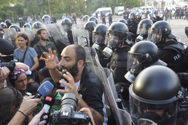 Hungarian riot police detain migrants