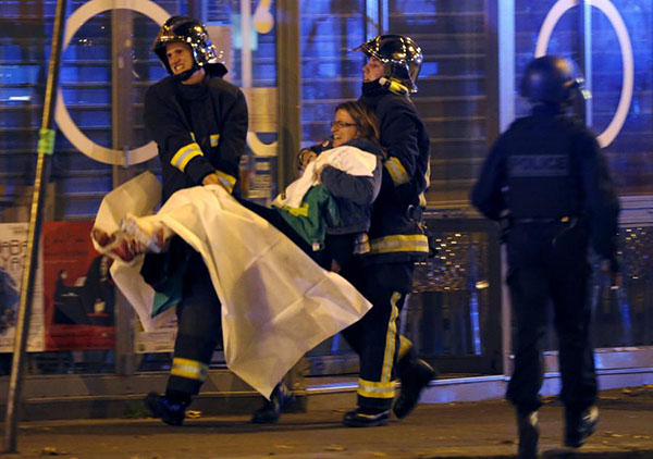 Over 100 dead in Paris shootings, hostages held: French media